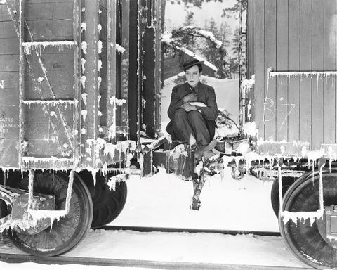 1925 american comedian buster keaton 1895 1966 sits shivering on the coupling between two railway containers in a scene from his latest film 'go west' photo by ricejohn kobal foundationgetty images