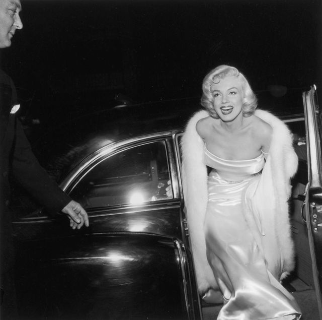 1954  exclusive american actor marilyn monroe 1926    1962 emerges from a car, wearing a strapless white gown and white fur coat at the premiere of director walter langs film theres no business like show business  photo by m garrettmurray garrettgetty images