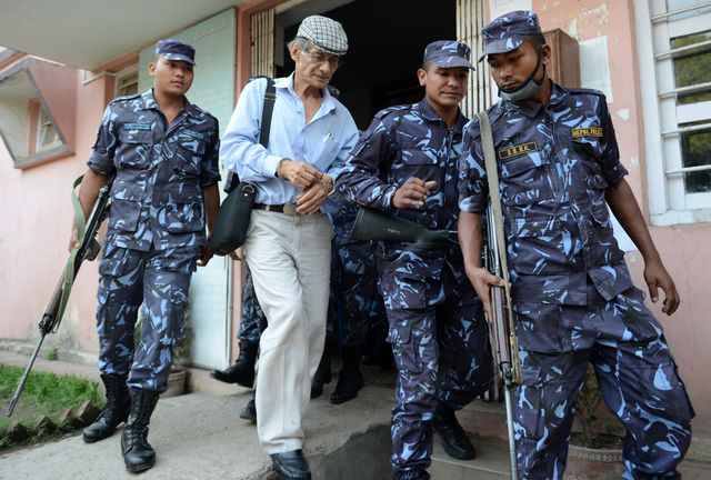 french serial killer charles sobhraj 2nd l is escorted by nepalese police to a waiting vehicle after a hearing at a district court on a case related to the murder of canadian backpacker laurent ormond carriere, in bhaktapur on june 12, 2014 sobhraj, a french citizen who is serving a life sentence in nepal for the murder of an american backbacker in 1975, has been linked with a string of killings across asia in the 1970s, earning the nickname bikini killer afp photoprakash mathema        photo credit should read prakash mathemaafp via getty images