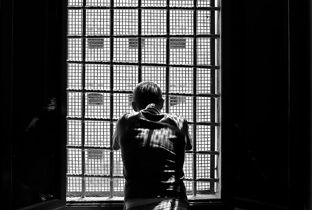 to go with afp story by ella ide
a prisoner looks out a window at regina coeli prison in rome on may 30, 2014 crouched on bunk beds in the narrow cells of the regina coeli lockup in rome, prisoners say italy still has a long way to go to ease a chronic overcrowding problem condemned by the european court of human rights afp photo  alberto pizzoli        photo credit should read alberto pizzoliafp via getty images