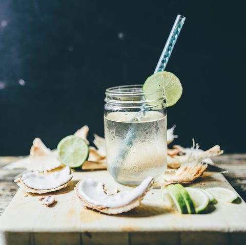 chilled coconut water in a jar with sliced lime