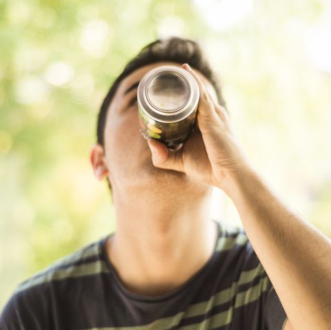 a young man drinking a can mens health diet soda weight gain loss