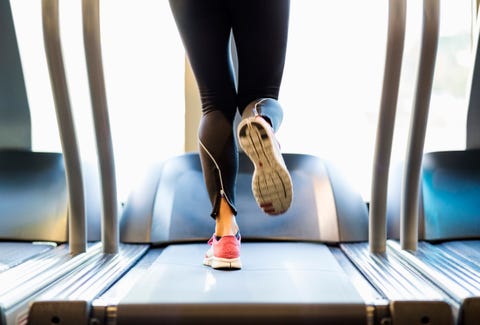 Low section of woman exercising on treadmill