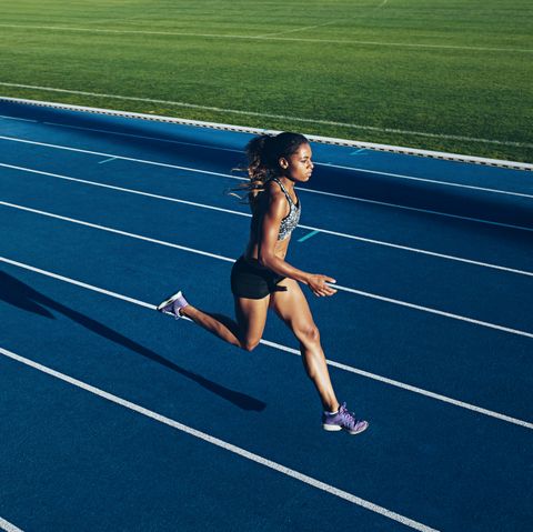 African woman running on racetrack