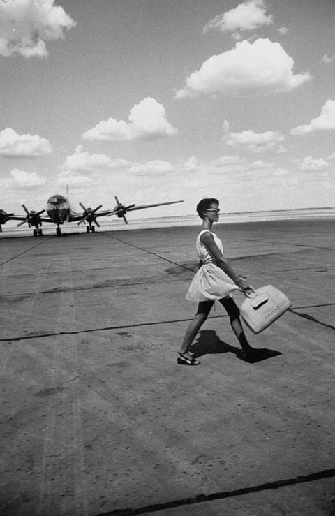 an american airline hostess crossing field on way to jobs as a model and sales clerk at neiman marcus  photo by lisa larsenthe life picture collection via getty images