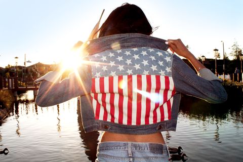 Girl With American Flag Jacket With Sunset