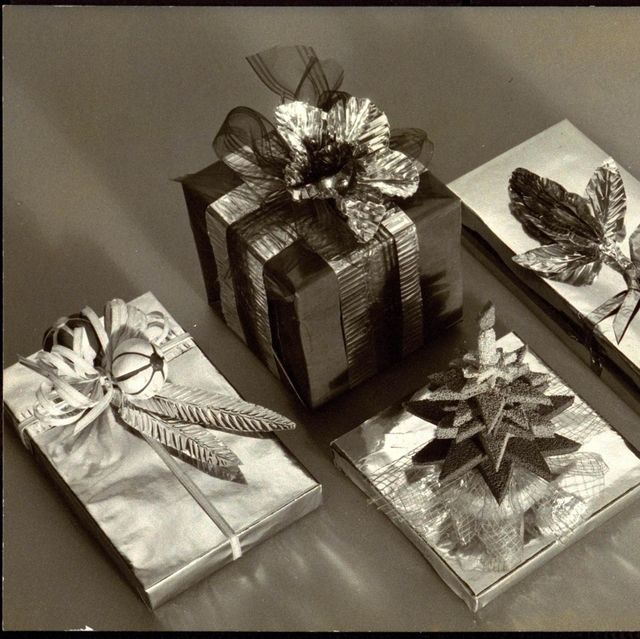 christmas decorations four wrapped presents with leaf, flower, and tree decorations, all by clem hall photo by martinus andersencondé nast via getty images
