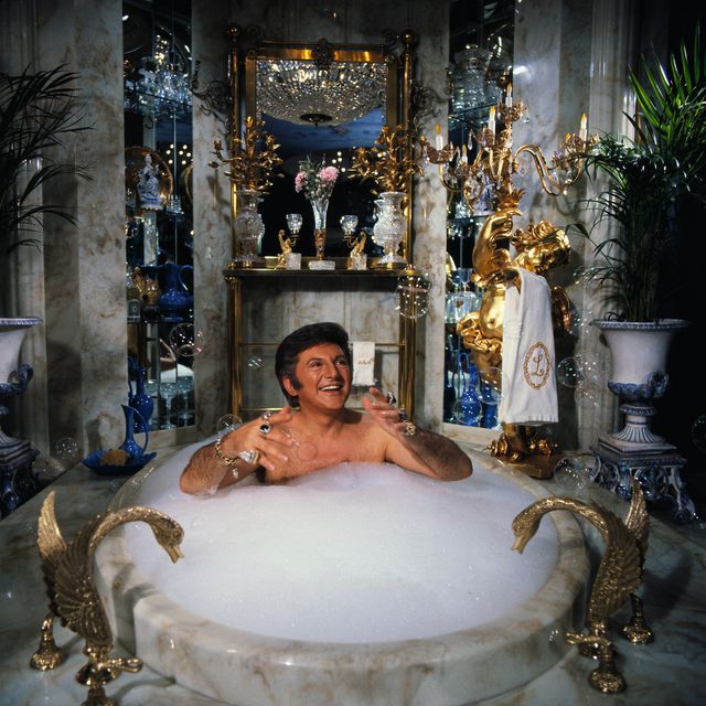 liberace spoofs a day in his own life during a television special, including a scene where he baths in his $55,000 marble bathtub