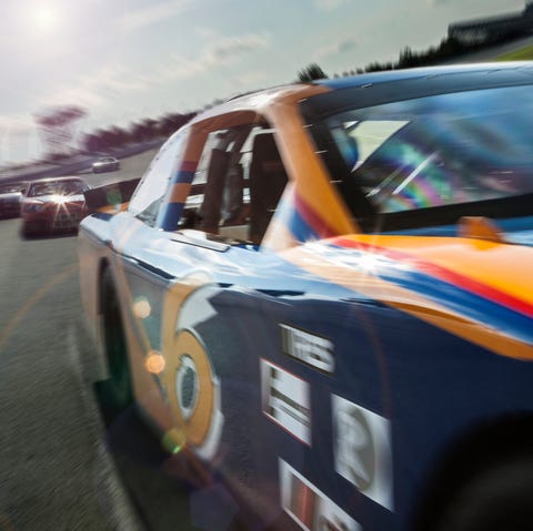 race car speeding down race track race car speeding down race track