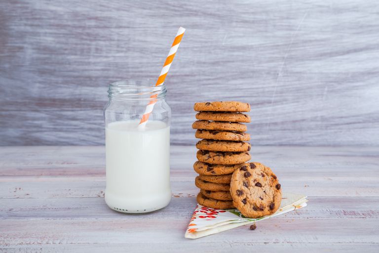 Stack of chocolate chip cookies and jar of milk