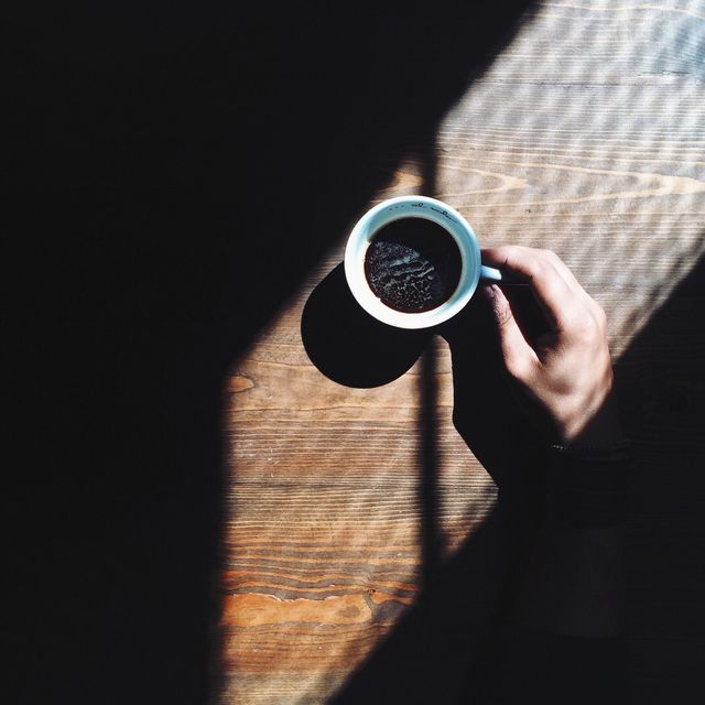 Cropped Image Of Person Having Coffee At Home