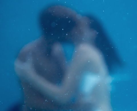 soft focus photo of young couple kissing, embracing under water, underwater love, together forever, falling in love