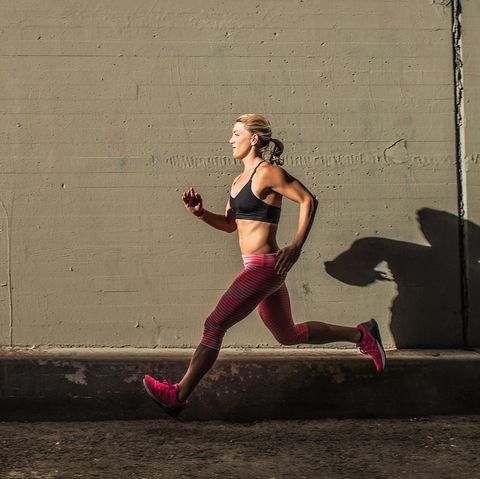 female runner running on sidewalk