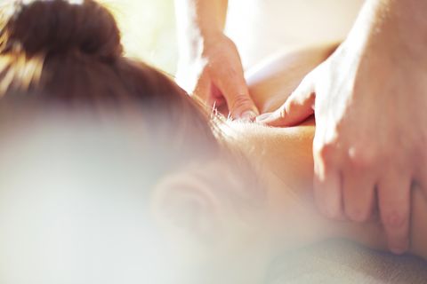 Close up masseuse massaging womans neck