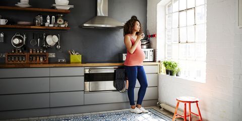 Pregnant Woman In Kitchen