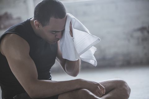 Athlete wiping sweat with towel