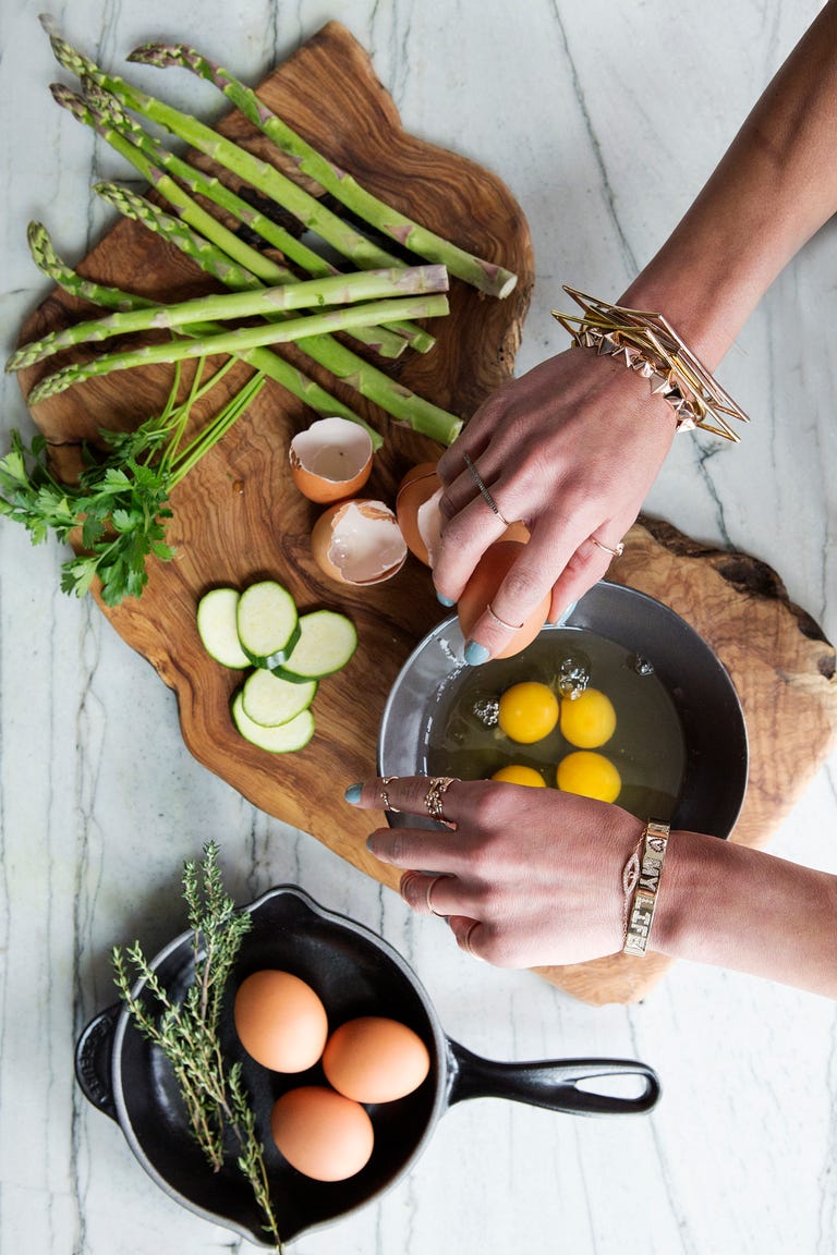 Woman's hands breaking eggs into a bowl