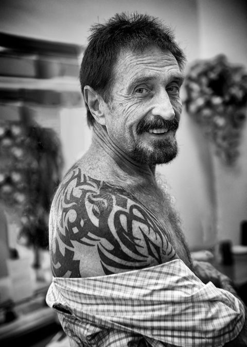 december 13, 2012   john mcafee showing his tattoo at the beacon hotel where he is staying after arriving from guatemala on december 13, 2012 in miami beach, florida mcafee is a person of interest in the fatal shooting of his neighbor in belize and turned up in guatemala after a month on the run in belize photo by michele eve sandbergcorbis via getty images