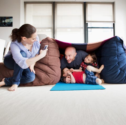 Family playing in pillow fort family playing in pillow fort