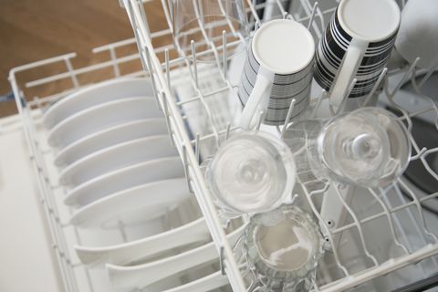 View from above of clean dishes in dishwasher.
