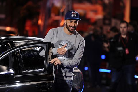 madrid, spain   november 04  karim benzema of real madrid salutes before getting into his new audi car for the 20162017 season at carlos sainz center on november 4, 2016 in madrid, spain audi, who are  the official sponsors of real madrid, has given each player a new audi car to promote their brand as part of the sponsorship deal  photo by denis doylegetty images