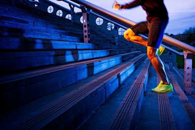 athletic legs of young sport man with sharp scarf muscles running on staircase steps, jogging in urban training workout runner competition in fitness and healthy lifestyle concept