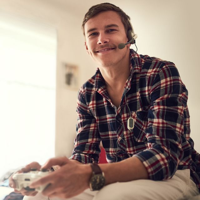 man playing xbox with a gaming headset