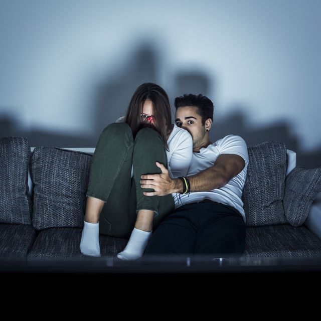 Young couple watching horror movie