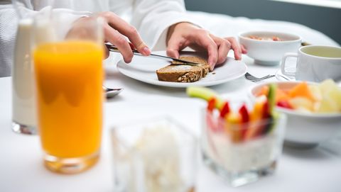 woman having healthy breakfast in a hotel room