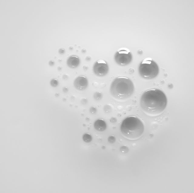 Full frame of the textures formed by the bubbles  in the shape of circle floating on a liquid  white color background
