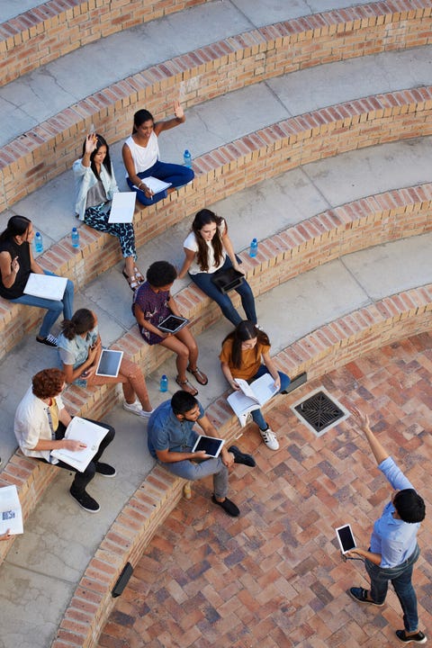 Students having class in outside auditorium Students having class in outside auditorium