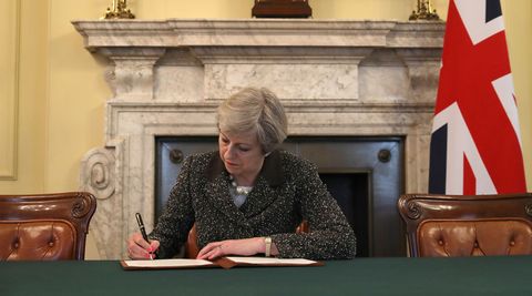 British Prime Minister Theresa May in the cabinet office signs the official letter to European Council President Donald Tusk invoking Article 50 and the United Kingdom's intention to leave the EU on March 28, 2017 in London, England. After holding a referendum in June 2016 the United Kingdom voted to leave the European Union, the signing of Article 50 now officially triggers that process.