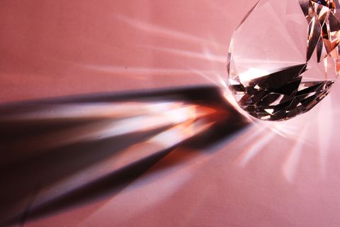 Close-Up Of Diamond With Shadow Pattern On Pink Table