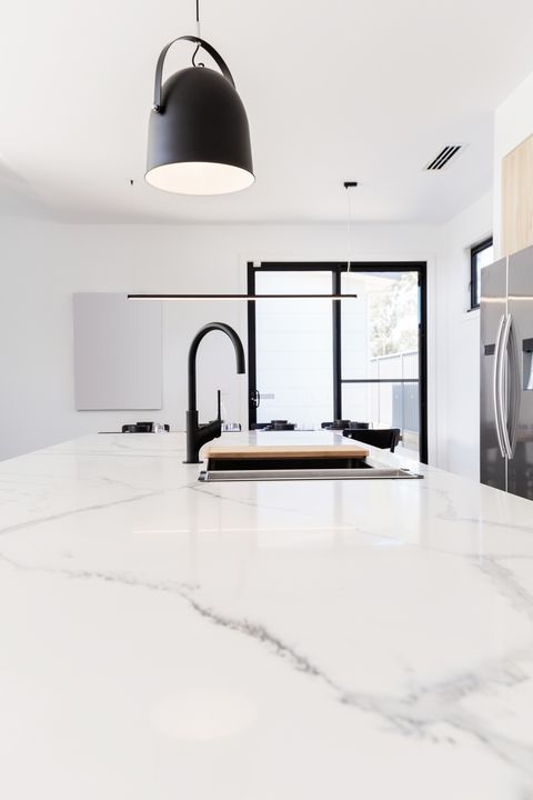 Carrera marble benchtop with black goose neck kitchen tap