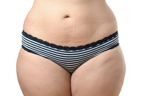 Midsection Of Woman Standing Against White Background