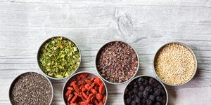 Bowls of chokeberries, chia, cocoa, quinoa, moringa and wolfberries