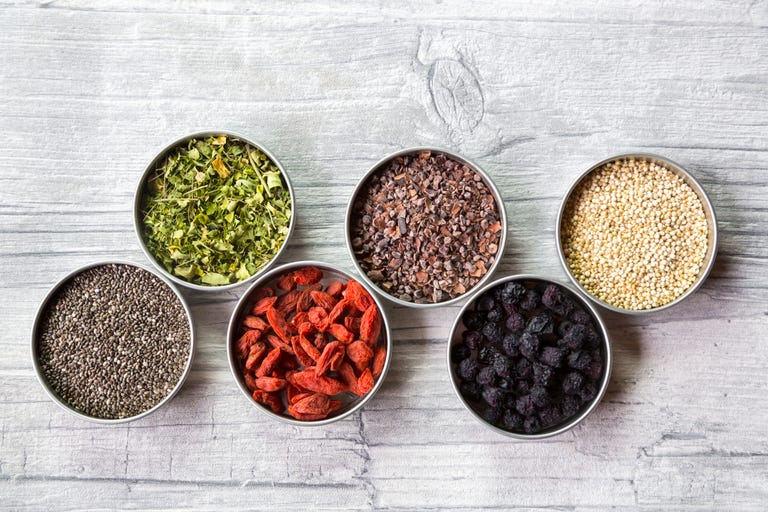 Bowls of chokeberries, chia, cocoa, quinoa, moringa and wolfberries