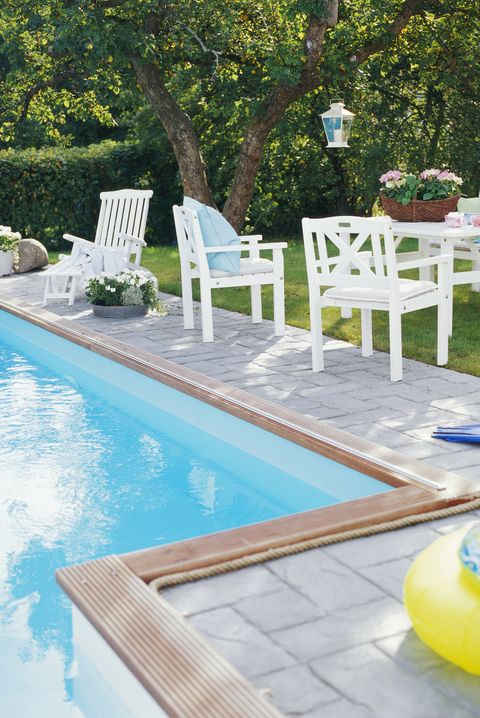 Outdoor furniture by a pool.