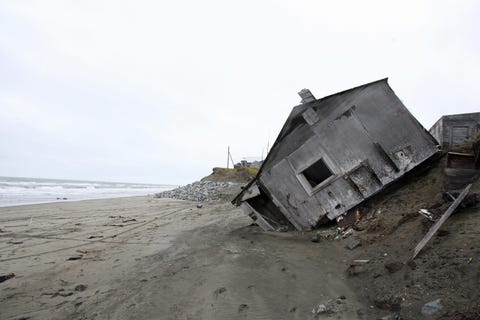 A home destroyed by beach erosion lies o