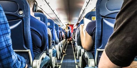 Rear View Of People Sitting In Airplane