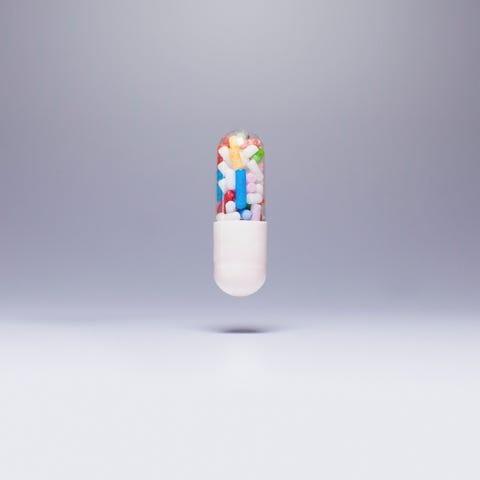 weight loss exercise Capsule containing sprinkles in mid-air against gray background weight loss exercise Capsule containing sprinkles in mid-air against gray background
