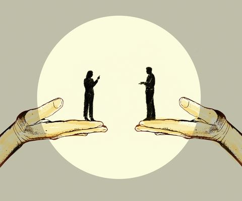 Man and woman discussing standing on top of supporting hands