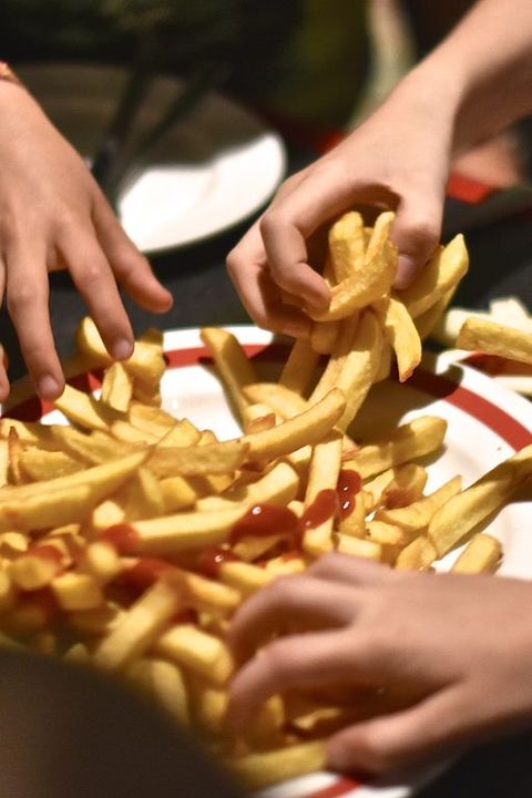 Children Grabbing French Fries