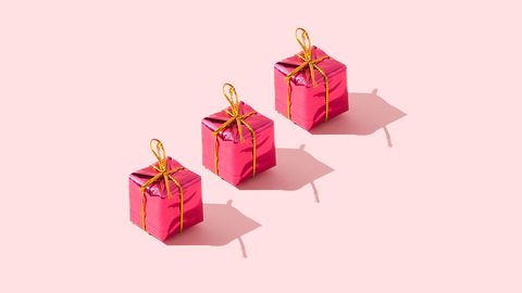 Three pink presents on a pink background