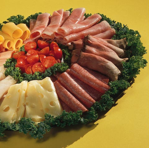 Platter of assorted cheeses and meats with garnish deli meat wreath