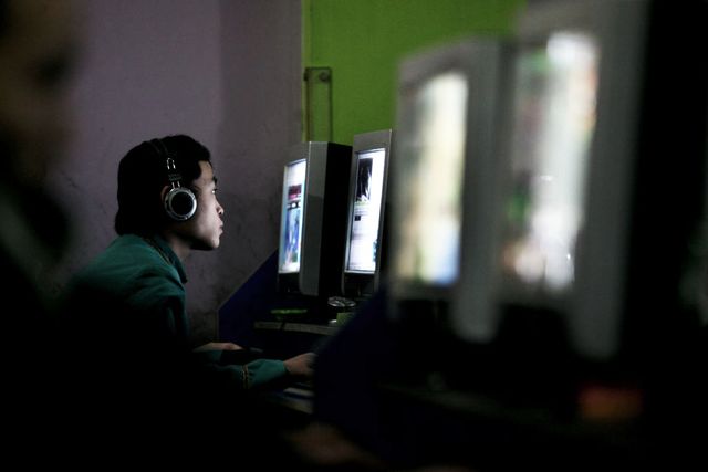 chongqing, china   january 21 china out a chinese youth plays online game in a net cafe on january 21, 2008 in chongqing municipality, china according to the china internet network information center cinic, china reported 210 million internet users at the end of 2007 and is set to surpass the usa to become the world's largest at the beginning of this year approximately one third of chinese netizens surfed the internet at net cafes photo by china photosgetty images