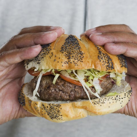 Hands holding hamburger man holds burger