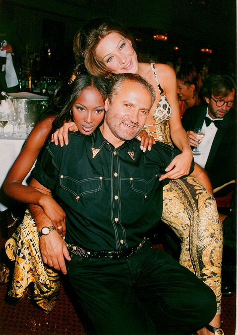 london   march 26 models carla bruni and naomi campbell pose with designer gianni versace at the save the rain forest gala dinner at the grovesnor house hotel hosted by sting on march 26, 1992 in london, england photo by dave m bennettgetty images