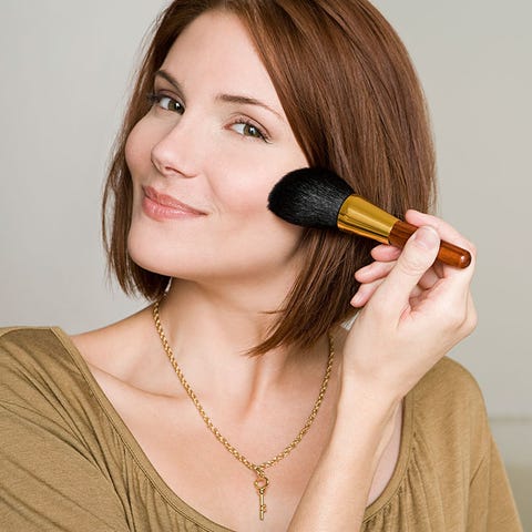 Applying makeup with brush Applying makeup with brush