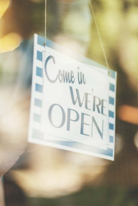 Man turning opening sign on door coffee shop Man turning opening sign on door coffee shop